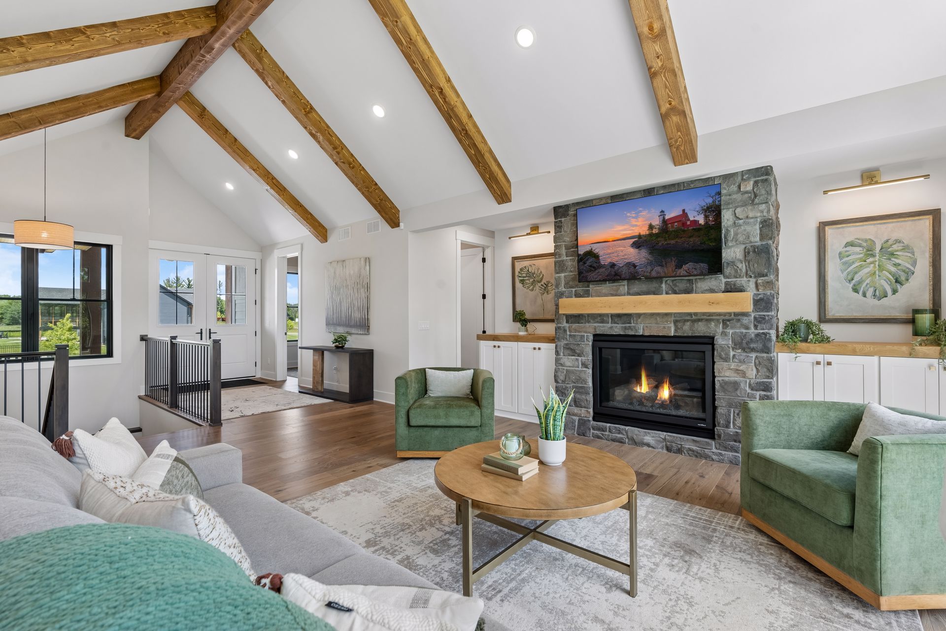 Luxury great room with fireplace built-ins and exposed timber beams